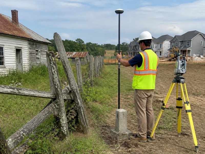 modern land surveyor using GPS equipment to identify property boundaries in mckinney texas
